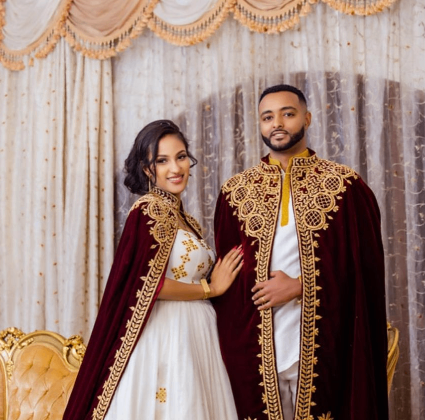 Stunning Ethiopian wedding couple in traditional habesha kemis and suit